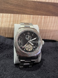 a watch sitting on a wooden box