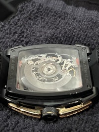 a black and gold watch with a skeleton on it