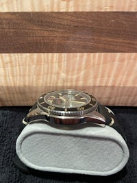 a watch sitting on top of a wooden box