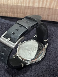 a black leather watch with a black strap