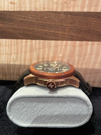 a watch is sitting on a wooden box