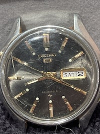 a seiko watch in a box with a black dial