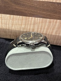 a watch sitting on a wooden box