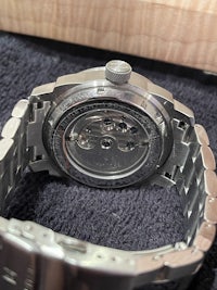 a close up of a stainless steel watch