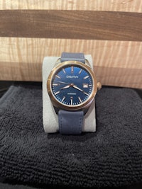 a blue watch sitting on top of a towel