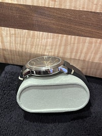 a watch sitting on top of a wooden box