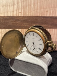 a pocket watch sitting on a table