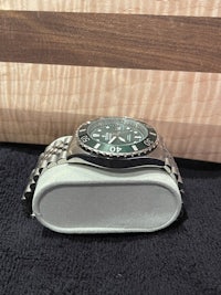 a watch sitting on top of a cutting board