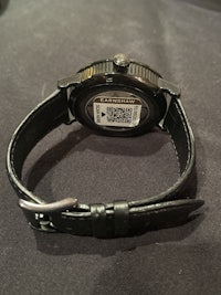a black watch with a qr code on it