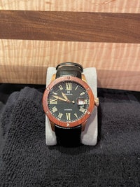 a watch with roman numerals on a black background