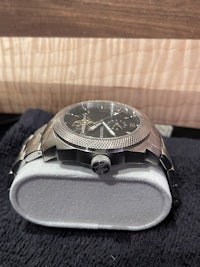 a watch is sitting on a wooden box