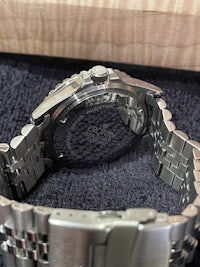 a stainless steel watch in a box