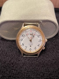 a gold watch sitting in a box