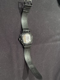 a black watch with a black strap on it