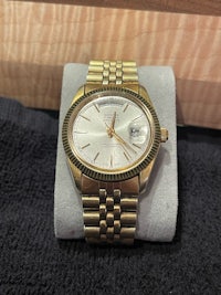 a gold watch sitting on a table