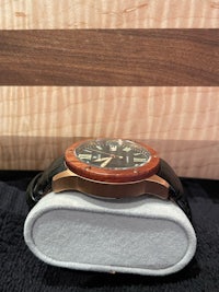 a watch sitting on top of a wooden box