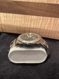 a watch sitting on a cutting board